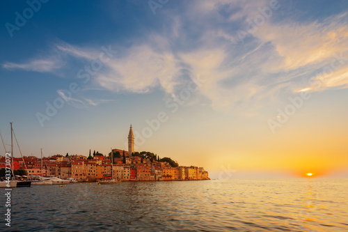 Wonderful morning view of old Rovinj town with multicolored buildings and yachts moored along embankment, Croatia.