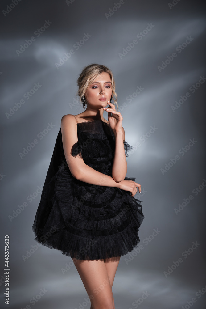 Fototapeta premium Fashionable blonde beautiful woman posing wearing white dress, Hight fashion portrait of young elegant women.
