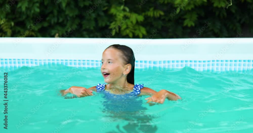 Happy little girl having fun in the swimming pool, dives and swim, Happy little girl having fun in the swimming pool, dives and swim,