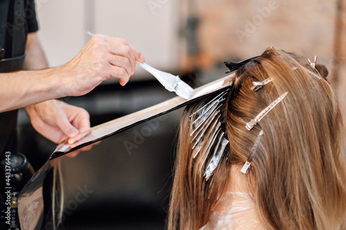 Airtouch technique. Hair stylist dyes hair