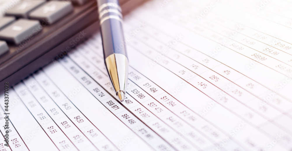 Calculator and pen on the financial documents, abstract accounting business concept Calculator and pen on the financial documents, abstract accounting business concept