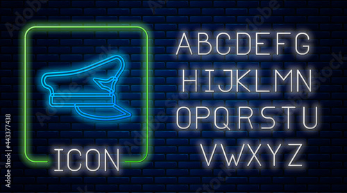 Glowing neon Pilot hat icon isolated on brick wall background. Neon light alphabet. Vector