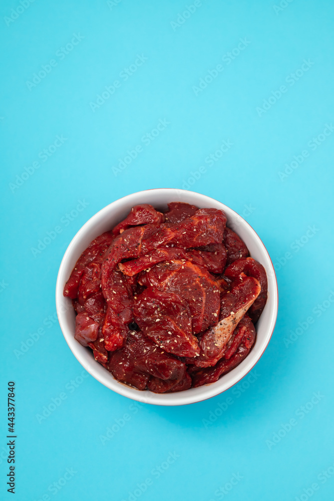 marinated raw meat with spices in red and white bowl marinated raw meat with spices in red and white bowl