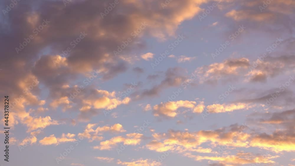 Time laps of pink flat clouds in the blue sky. Time laps of pink flat clouds in the blue sky.