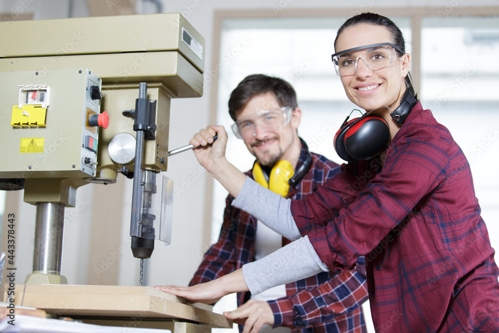 engineer training female apprentice to use cnc machine in factory engineer training female apprentice to use cnc machine in factory