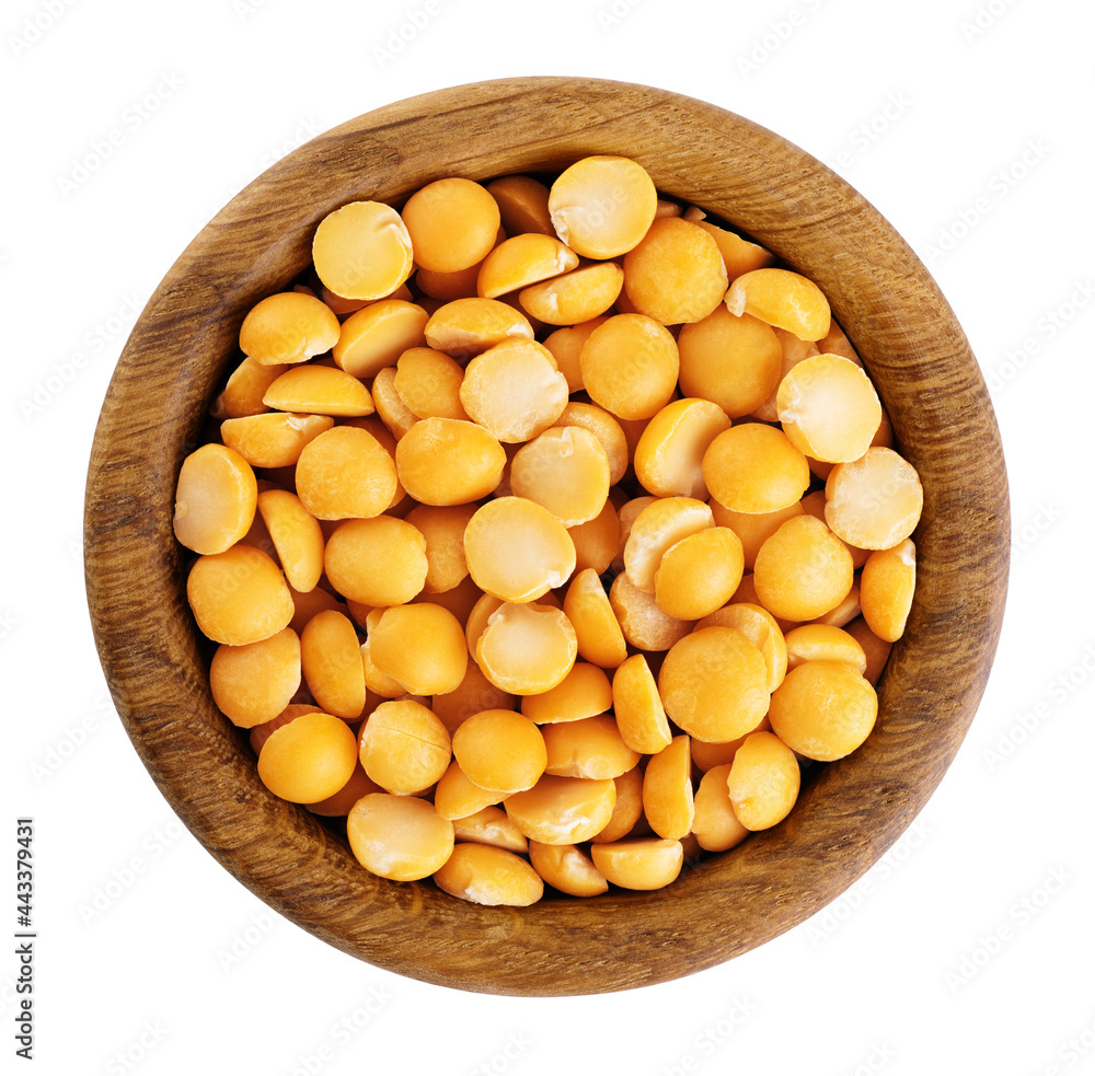 Yellow split peas in a wooden bowl isolated on white background. With clipping path. Yellow split peas in a wooden bowl isolated on white background. With clipping path.
