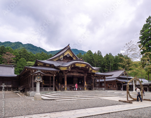 Main shrine and cogon grass ring (through which people pass as purification rite) (Yahiko shrine, Yahiko, Niigata, Japan)