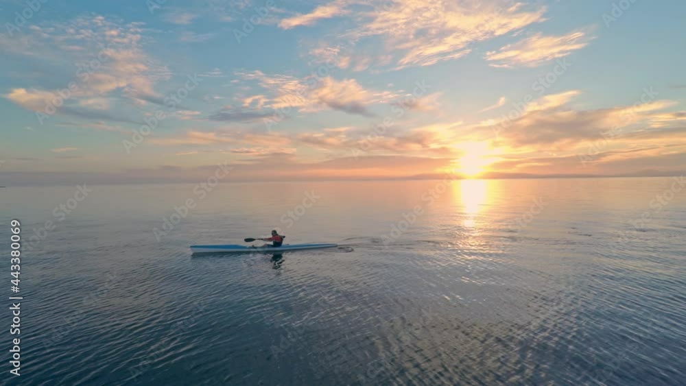 Man in Kayak in calm ocean water at sunset. San Francisco, California, USA Man in Kayak in calm ocean water at sunset. San Francisco, California, USA