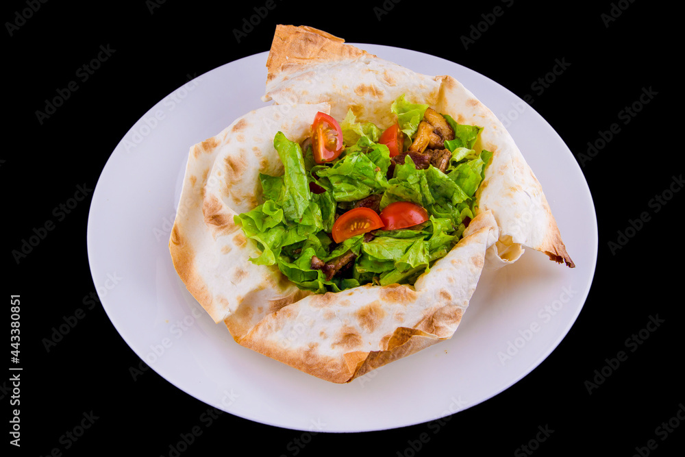 Warm salad in thin pita bread: beef, mushrooms, cherry tomatoes, Dijon mustard, cognac.