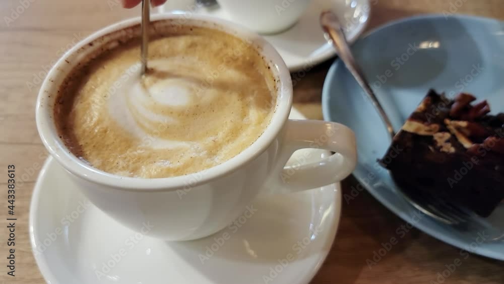 Cup of coffee and cake close-up in a cozy cafe.