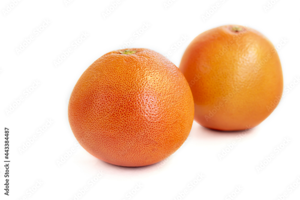 Grapefruit on a white plate with a sprig of mint. Isolate. Grapefruit on a white plate with a sprig of mint. Isolate.