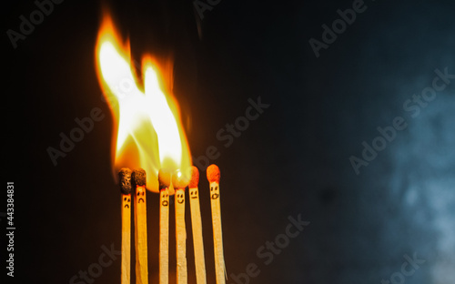 Group of a red match burning isolated with the background. Row burning matchstick in the chain reaction. Matchstick art photography.