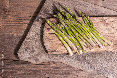 Ripe asparagus ready for cooking on vintage wooden stands