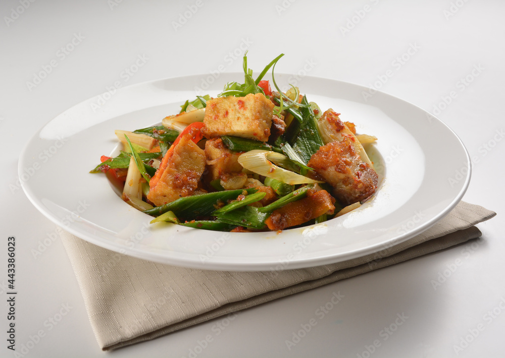stir fried vegetable with bean curd tofu in spicy sambal chilli sauce in white plate asian halal menu stir fried vegetable with bean curd tofu in spicy sambal chilli sauce in white plate asian halal menu