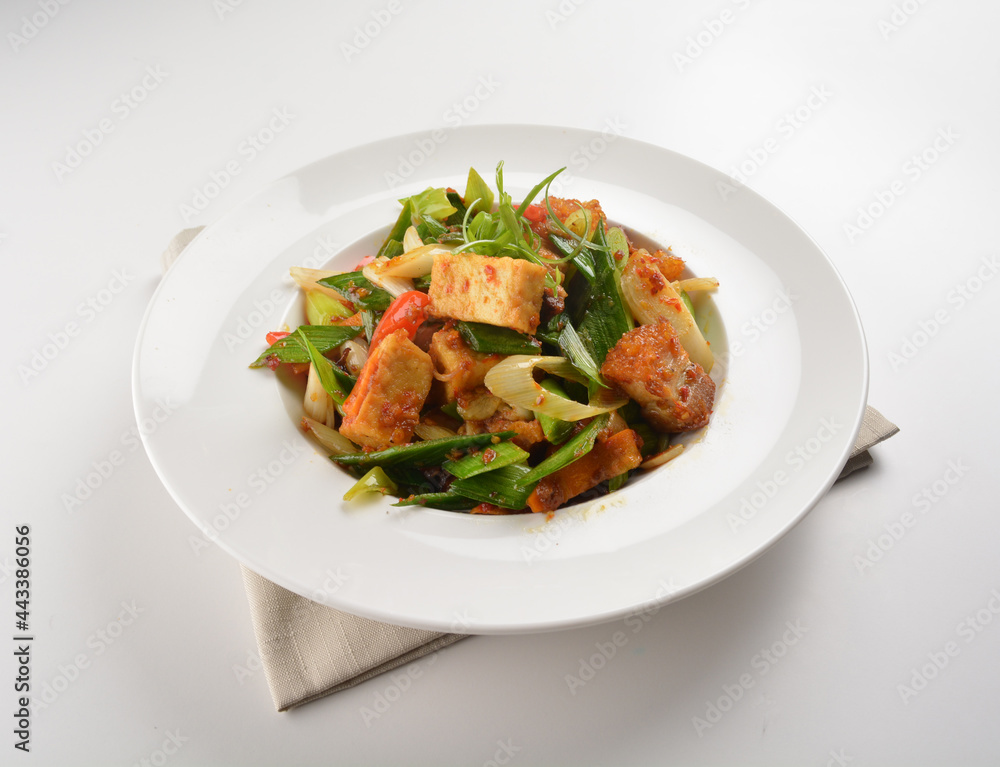 stir fried vegetable with bean curd tofu in spicy sambal chilli sauce in white plate asian halal menu stir fried vegetable with bean curd tofu in spicy sambal chilli sauce in white plate asian halal menu