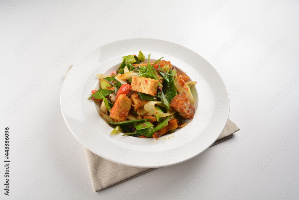 stir fried vegetable with bean curd tofu in spicy sambal chilli sauce in white plate asian halal menu stir fried vegetable with bean curd tofu in spicy sambal chilli sauce in white plate asian halal menu