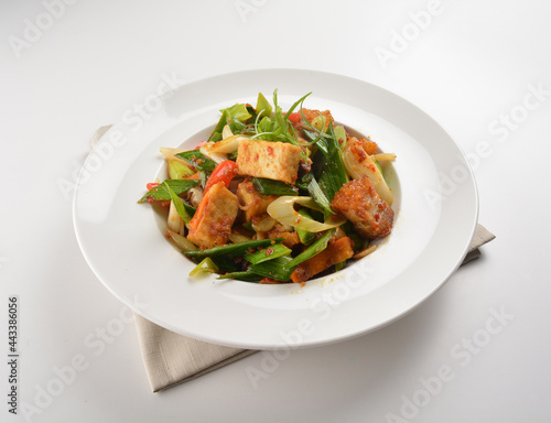 stir fried vegetable with bean curd tofu in spicy sambal chilli sauce in white plate asian halal menu