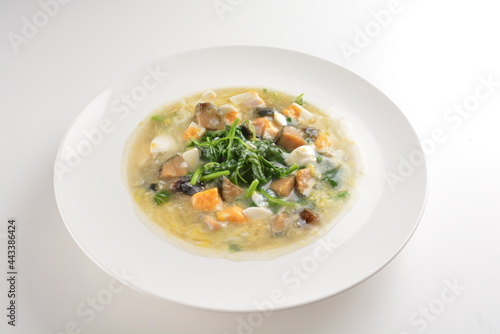 stir fried water spinach vegetable with trio eggs in thick gravy sauce in white plate asian halal menu