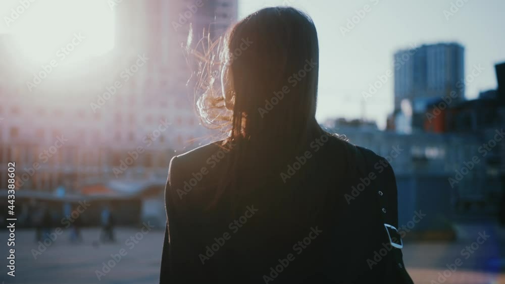Shot back young woman look around outside business district. Confident girl. Fashion, trendy, girl, urban, outdoor, beauty, businesswoman. Slow motion