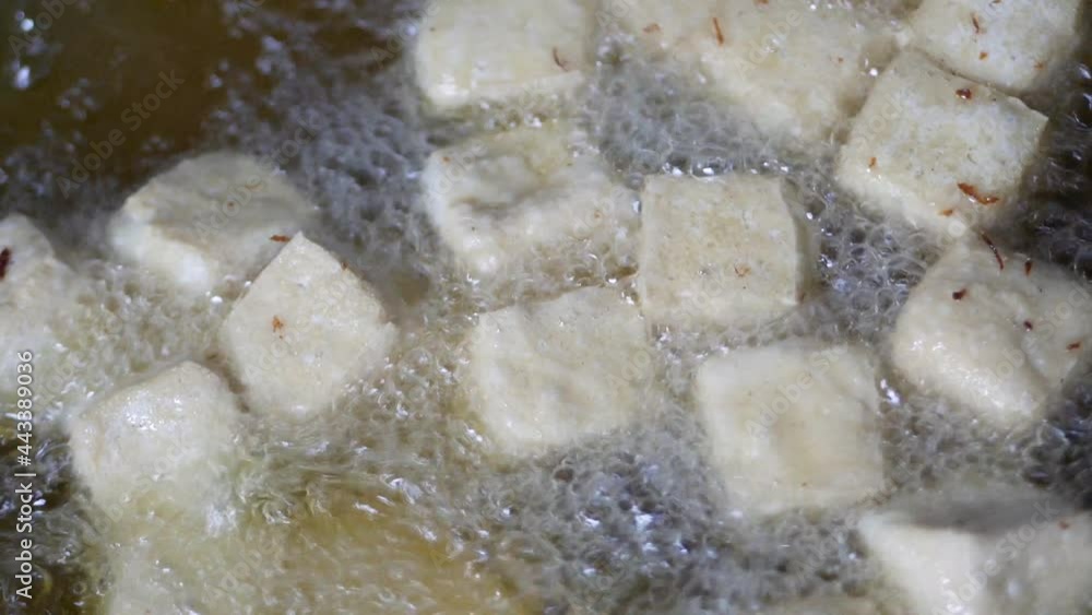 Close up deep frying tofu on wok. fring tofu cubes in wok Close up deep frying tofu on wok. fring tofu cubes in wok