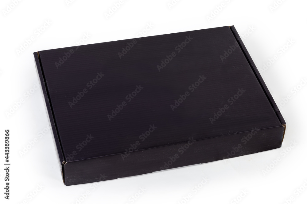 Closed black flat cardboard packing box on a white background Closed black flat cardboard packing box on a white background