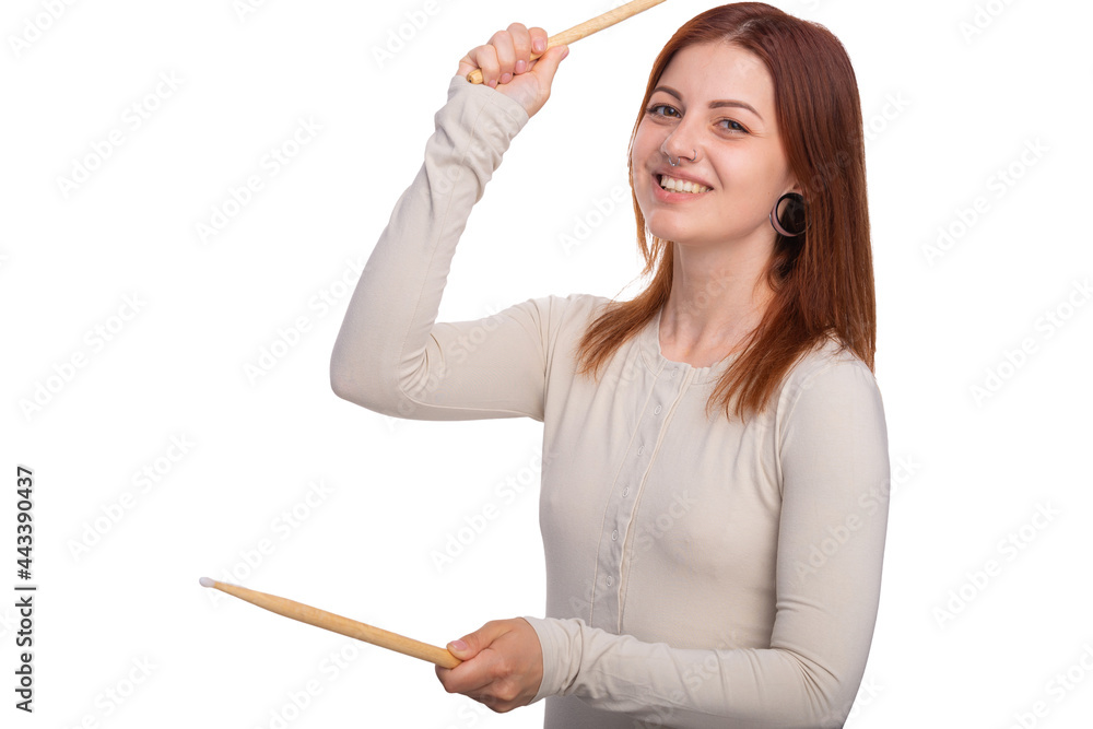 Rock and roll music concept. Young woman face with piercing shows her tongue and and holds drumsticks in his hands on a white background background. Free space for advertisement. Rock and roll music concept. Young woman face with piercing shows her tongue and and holds drumsticks in his hands on a white background background. Free space for advertisement.