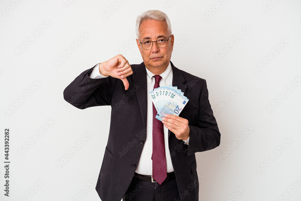 Senior american business man holding bills isolated on white background showing a dislike gesture, thumbs down. Disagreement concept. Senior american business man holding bills isolated on white background showing a dislike gesture, thumbs down. Disagreement concept.