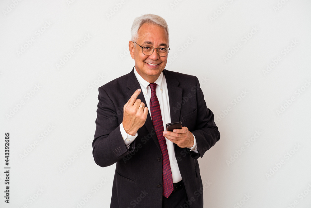 Senior business american man holding mobile phone isolated on white background pointing with finger at you as if inviting come closer. Senior business american man holding mobile phone isolated on white background pointing with finger at you as if inviting come closer.
