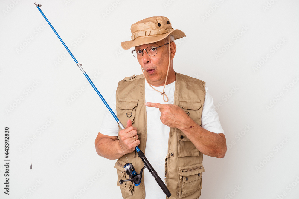 Senior american fisherman holding rod isolated on white background pointing to the side Senior american fisherman holding rod isolated on white background pointing to the side