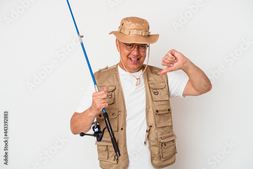 Senior american fisherman holding rod isolated on white background feels proud and self confident, example to follow.