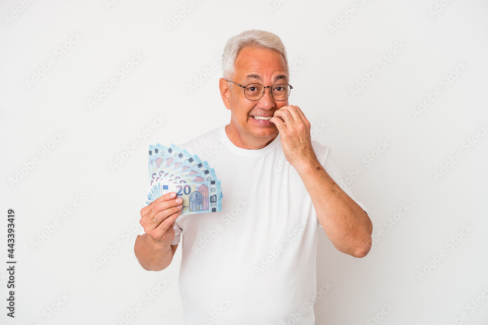 Senior american man holding bill isolated on white background biting fingernails, nervous and very anxious. Senior american man holding bill isolated on white background biting fingernails, nervous and very anxious.