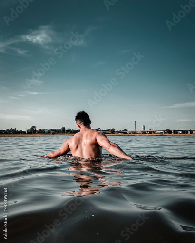 Muscular athletic man in the river