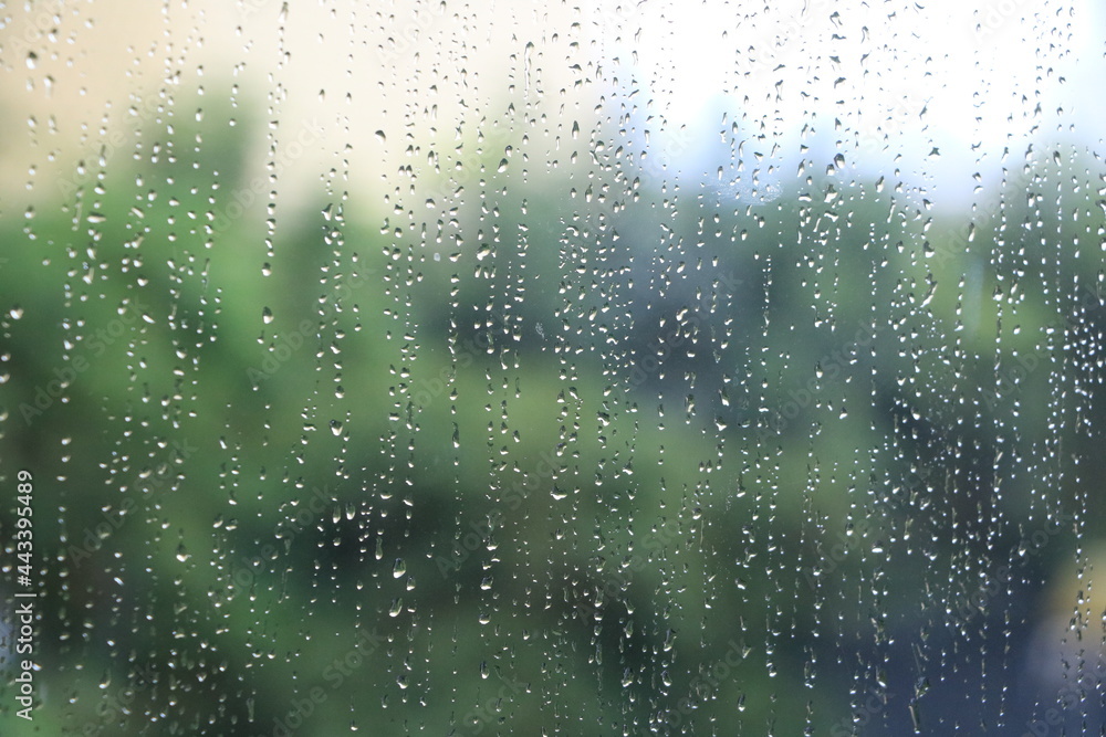 Close up of glass with rainy drops and blur background