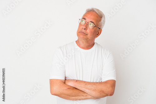 Senior american man isolated on white background tired of a repetitive task.