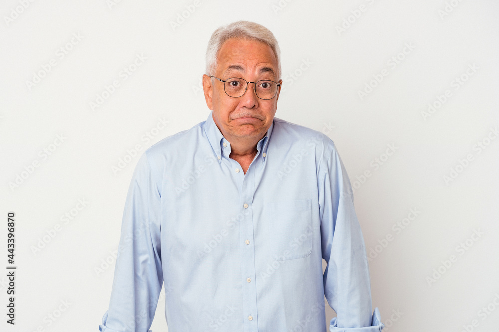 Senior american man isolated on white background shrugs shoulders and open eyes confused. Senior american man isolated on white background shrugs shoulders and open eyes confused.