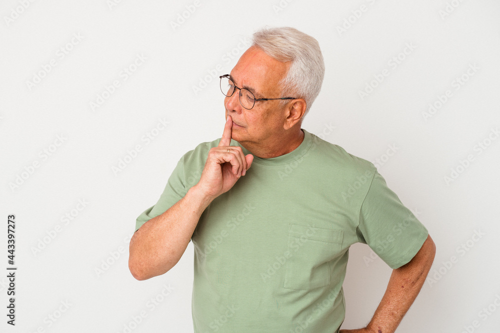 Senior american man isolated on white background keeping a secret or asking for silence. Senior american man isolated on white background keeping a secret or asking for silence.