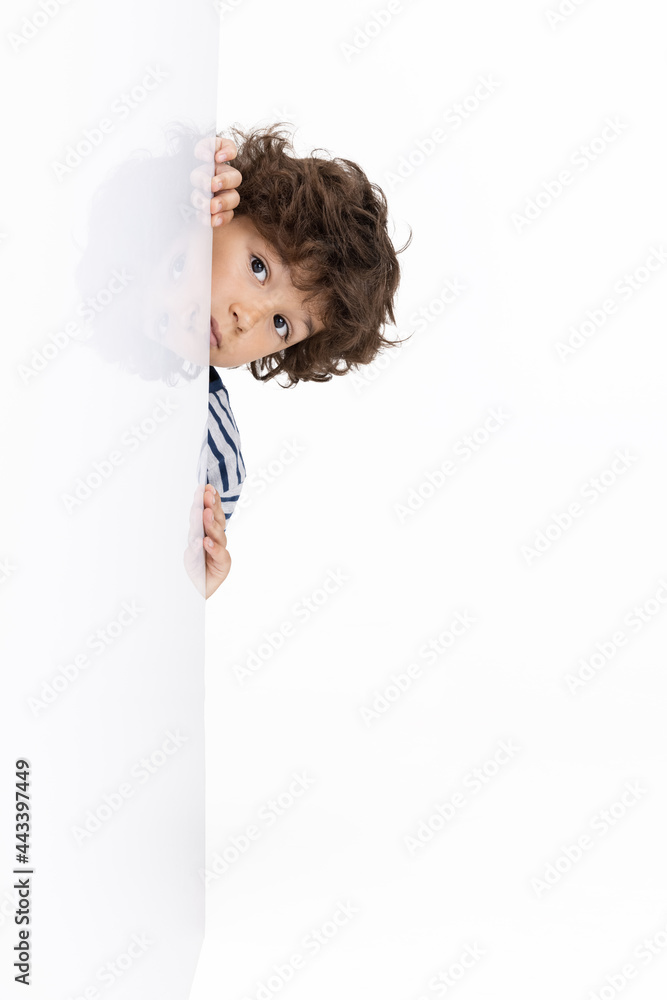 One Caucasian preschool boy isolated on white studio background. Copyspace. Childhood, education, emotions concept One Caucasian preschool boy isolated on white studio background. Copyspace. Childhood, education, emotions concept