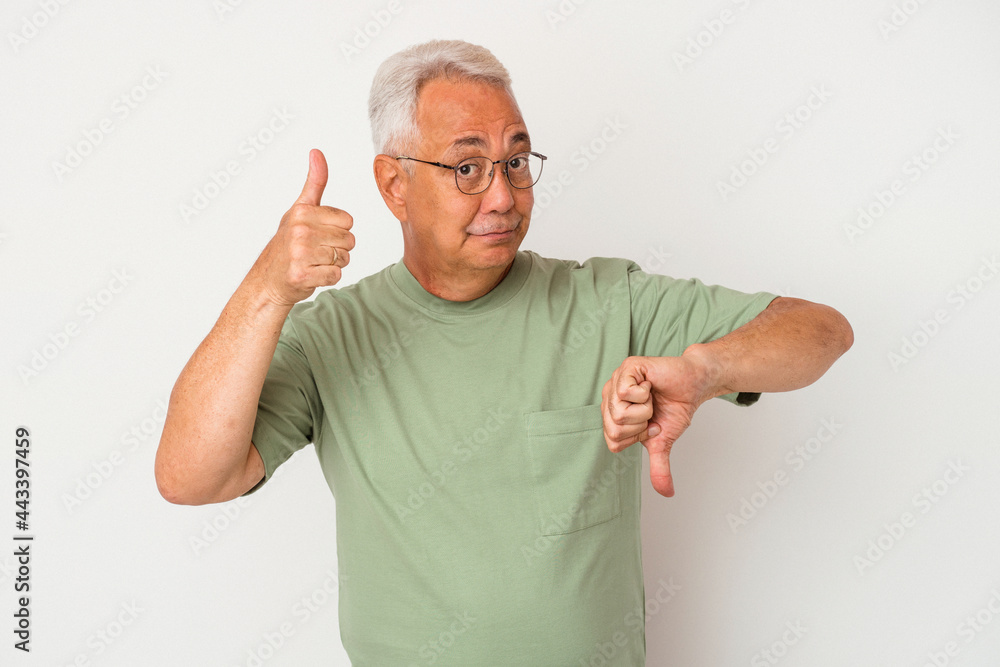 Naklejka premium Senior american man isolated on white background showing thumbs up and thumbs down, difficult choose concept