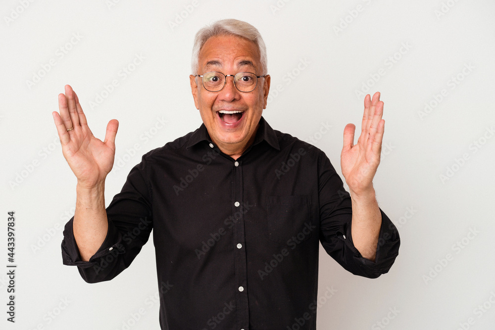 Senior american man isolated on white background receiving a pleasant surprise, excited and raising hands. Senior american man isolated on white background receiving a pleasant surprise, excited and raising hands.