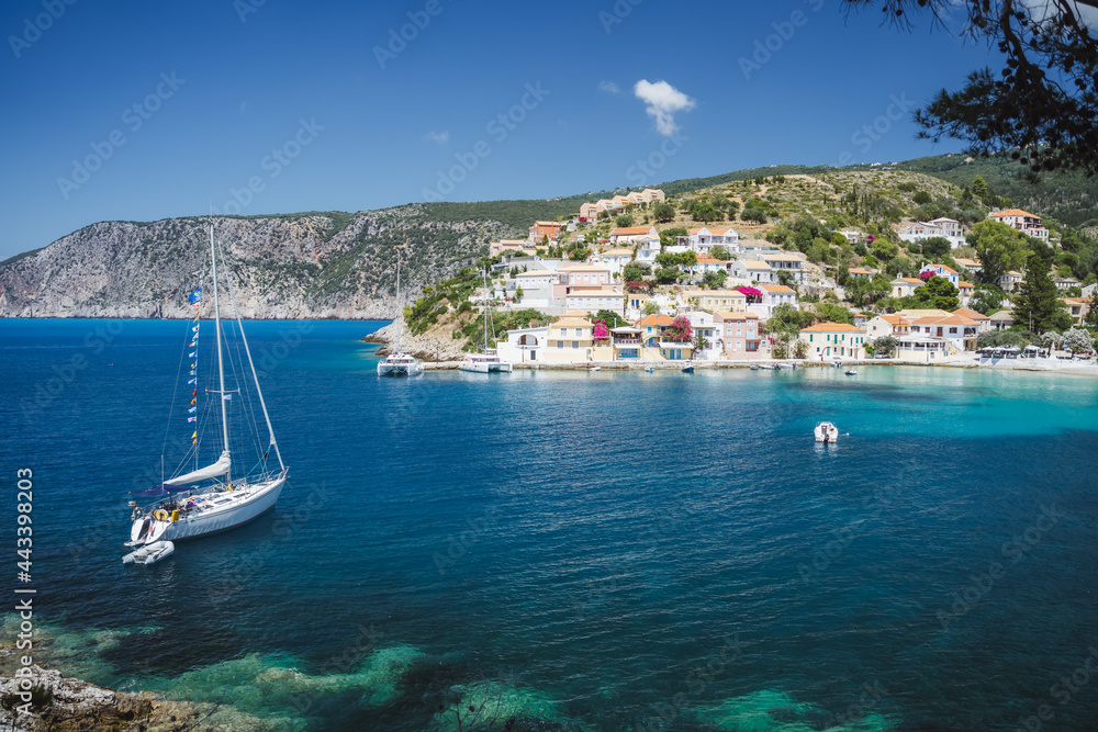 Sailing yacht boat in small bay of Assos cute town on Ionian coast, Kefalonia island, Greece