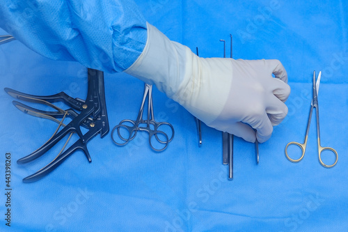 Surgeon holds scalpel in operating theatre