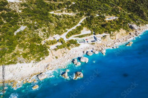 Fototapeta Naklejka Na Ścianę i Meble -  Aerial view of zig-zag road and Kalamitsi beach, Ionian Sea, Lefkada island, Greece.