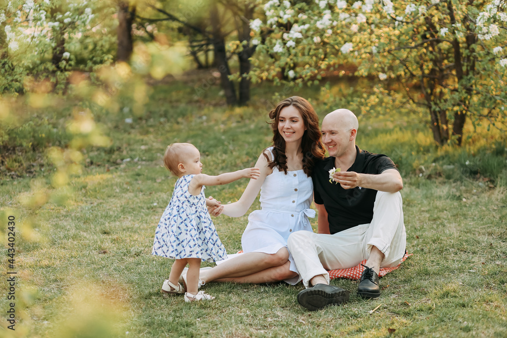 A happy young family with one small child walking having fun laughing spending time together in the park in nature on vacation in the summer outdoors, family day A happy young family with one small child walking having fun laughing spending time together in the park in nature on vacation in the summer outdoors, family day