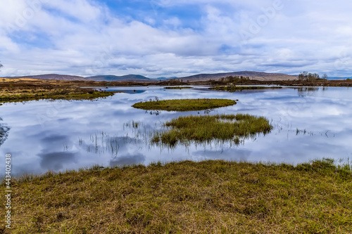 A view across the shallow waters of Loch Ba near Glencoe, Scotland on a summers day