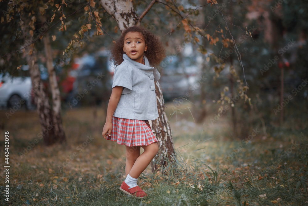 Adorable little girl outdoors at beautiful autumn day