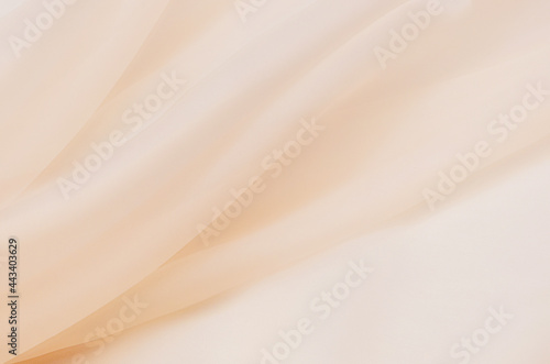 Abstract background texture of natural ivory color fabric. Fabric texture of natural cotton or linen, silk or satin, wool or jersey textile material. Luxurious beige canvas background.