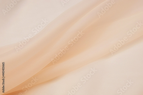 Abstract texture of natural beige or brown color fabric as concept background. Fabric texture of natural cotton or linen, silk or satin, wool or jersey textile material. Luxurious dark background. photo