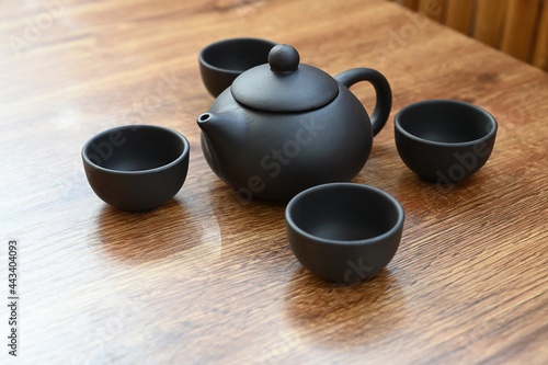 tea set made of black clay on a brown table