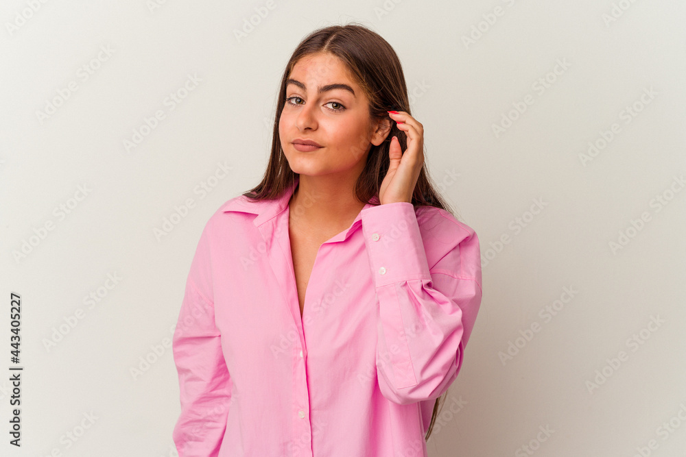 Young caucasian woman isolated on white background trying to listening a gossip. Young caucasian woman isolated on white background trying to listening a gossip.