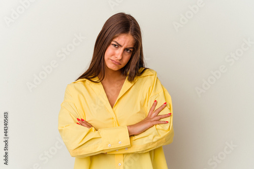 Young caucasian woman isolated on white background blows cheeks, has tired expression. Facial expression concept.